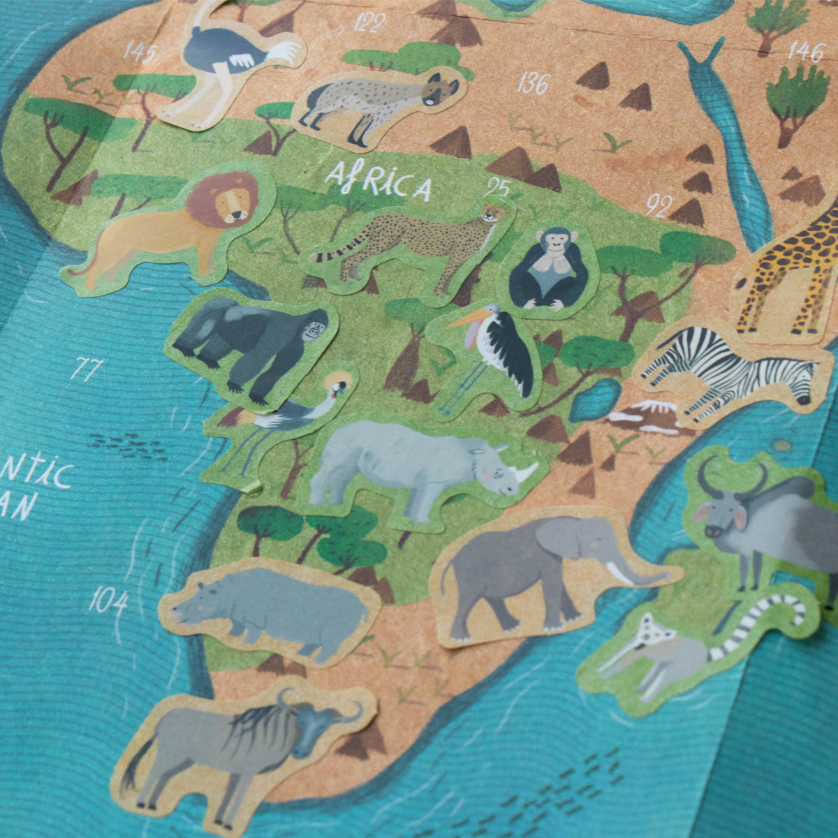 Londji Animal World sticker sheet with animals placed on the corresponding regions of the illustrated world map.