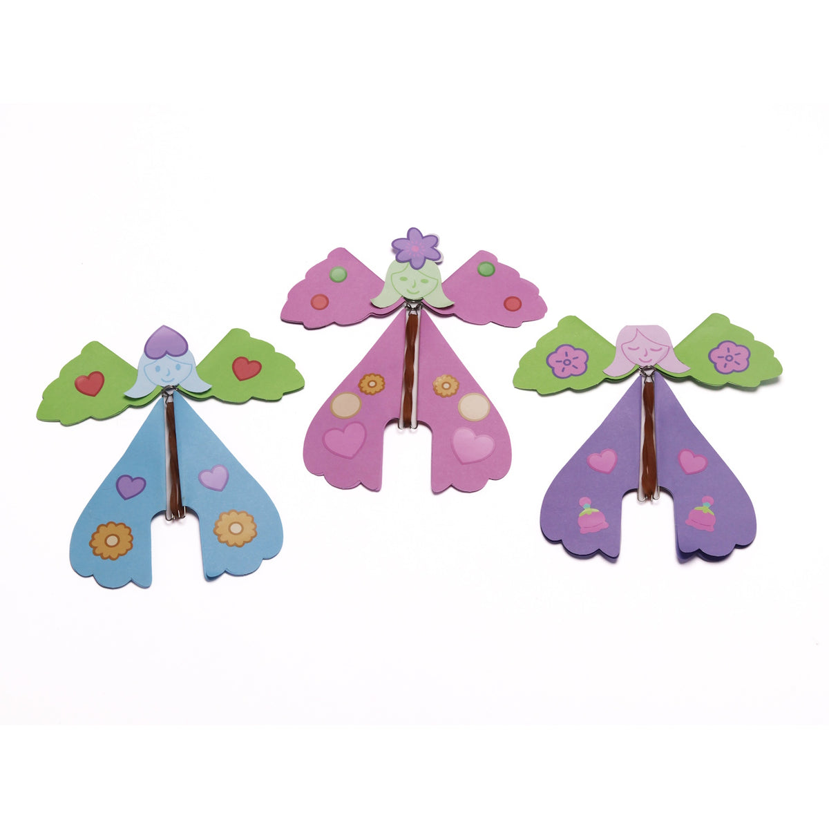 Three colorful paper flying fairies with rubber band mechanisms lined up on a white background.