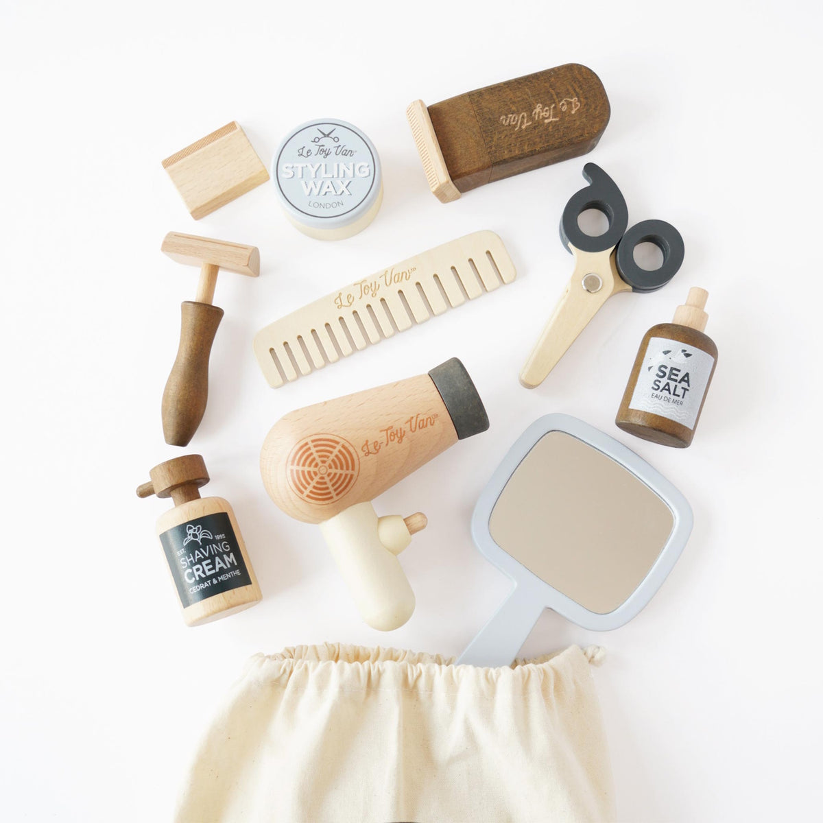 Wooden hairdresser and barber toy kit with scissors, hairdryer, mirror, comb, and accessories.