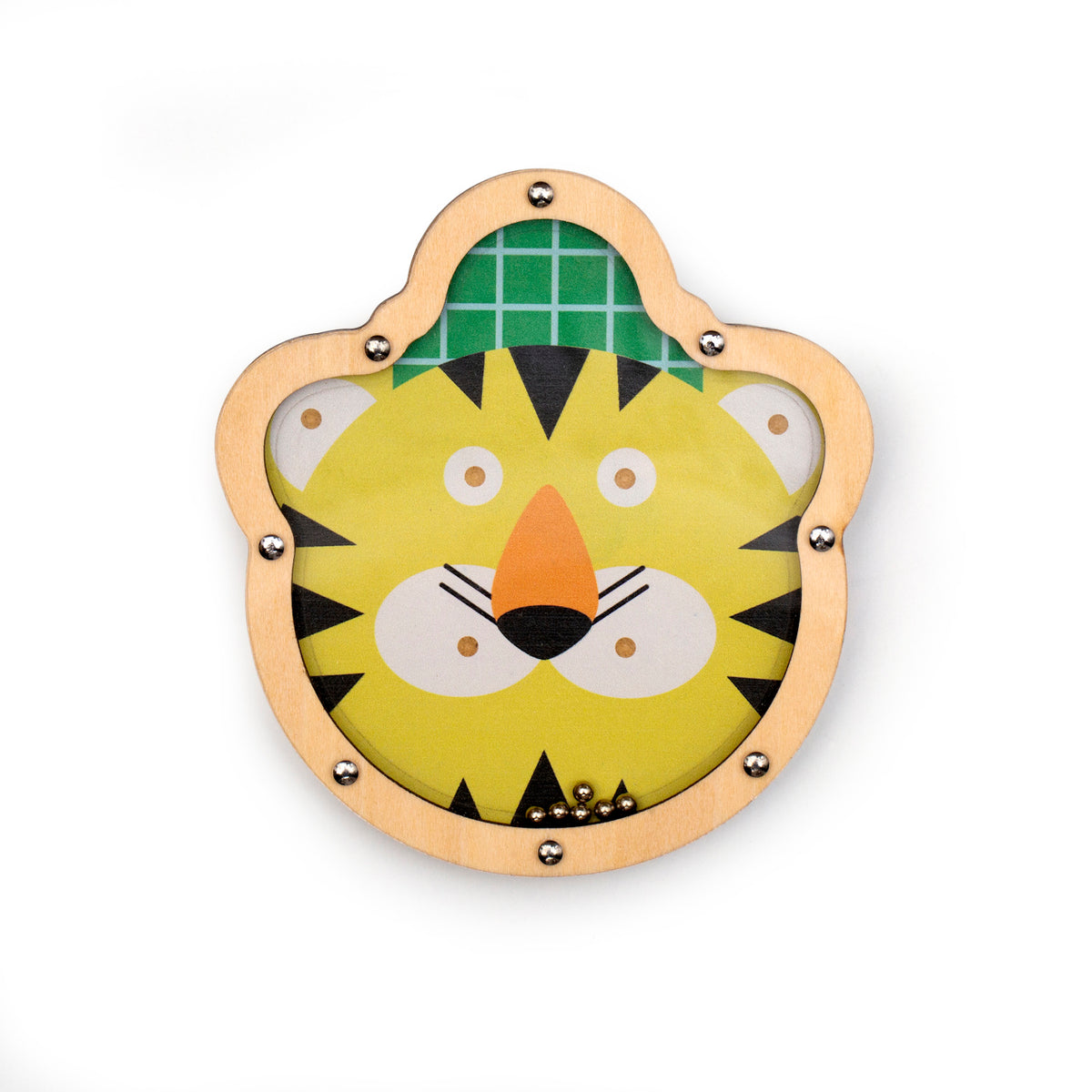 Wooden puzzle depicting a smiling cartoon tiger face with a yellow background and green grid pattern. Small metal balls are inside. Playful tone.
