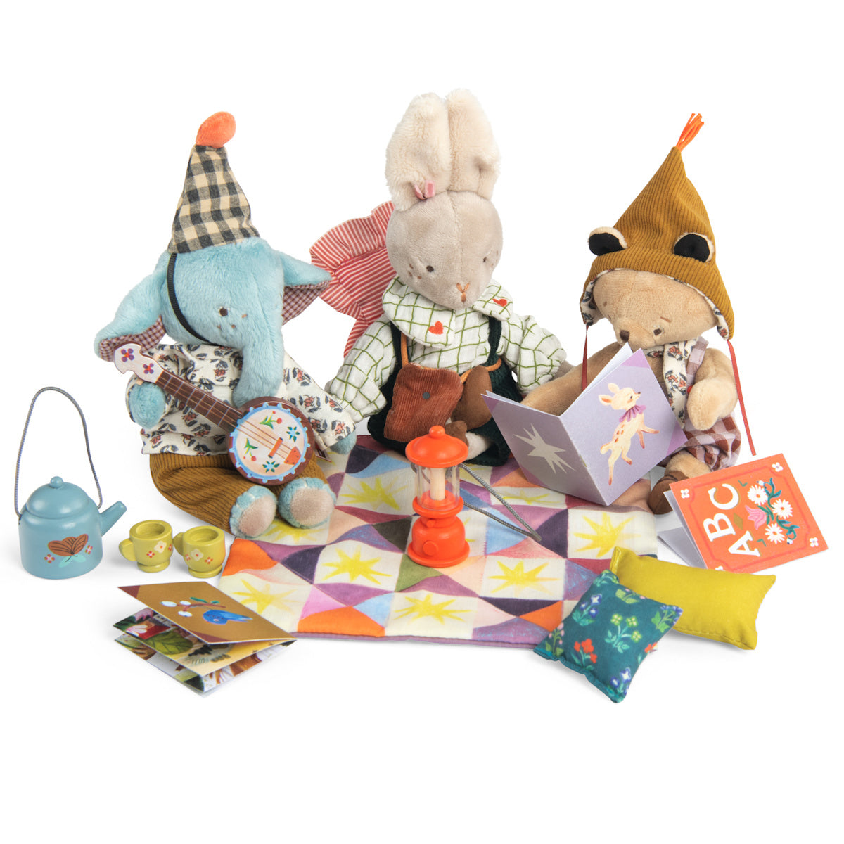 Moulin Roty Les Minouchkas plush toys camping on a blanket with fireside tea set, banjo and lantern.