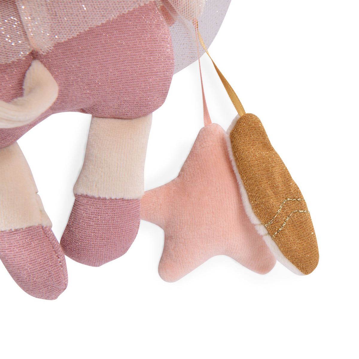 Close-up of a pink plush toy with hanging fabric attachments, including a soft pink star and a glittery gold slipper.