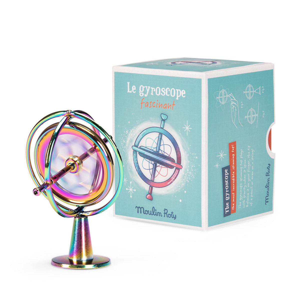 Moulin Roty rainbow metal gyroscope toy spinning on its stand next to its original blue product box.