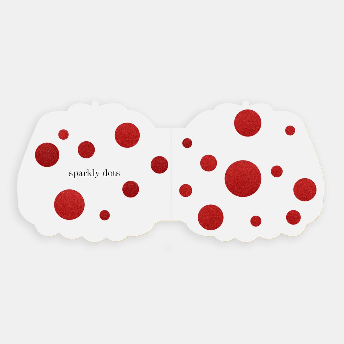 Shaped board book spread showing "sparkly dots" featured as red glittery circles on a white background.