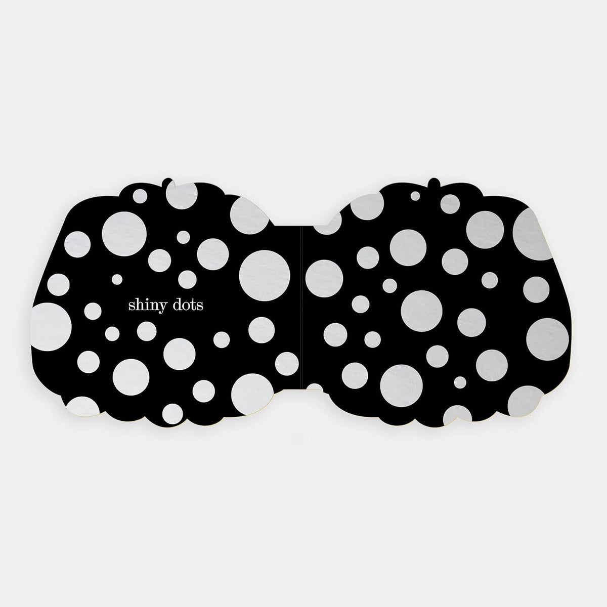 Shaped board book spread showing "shiny dots" featured as silver foil circles across a black background.