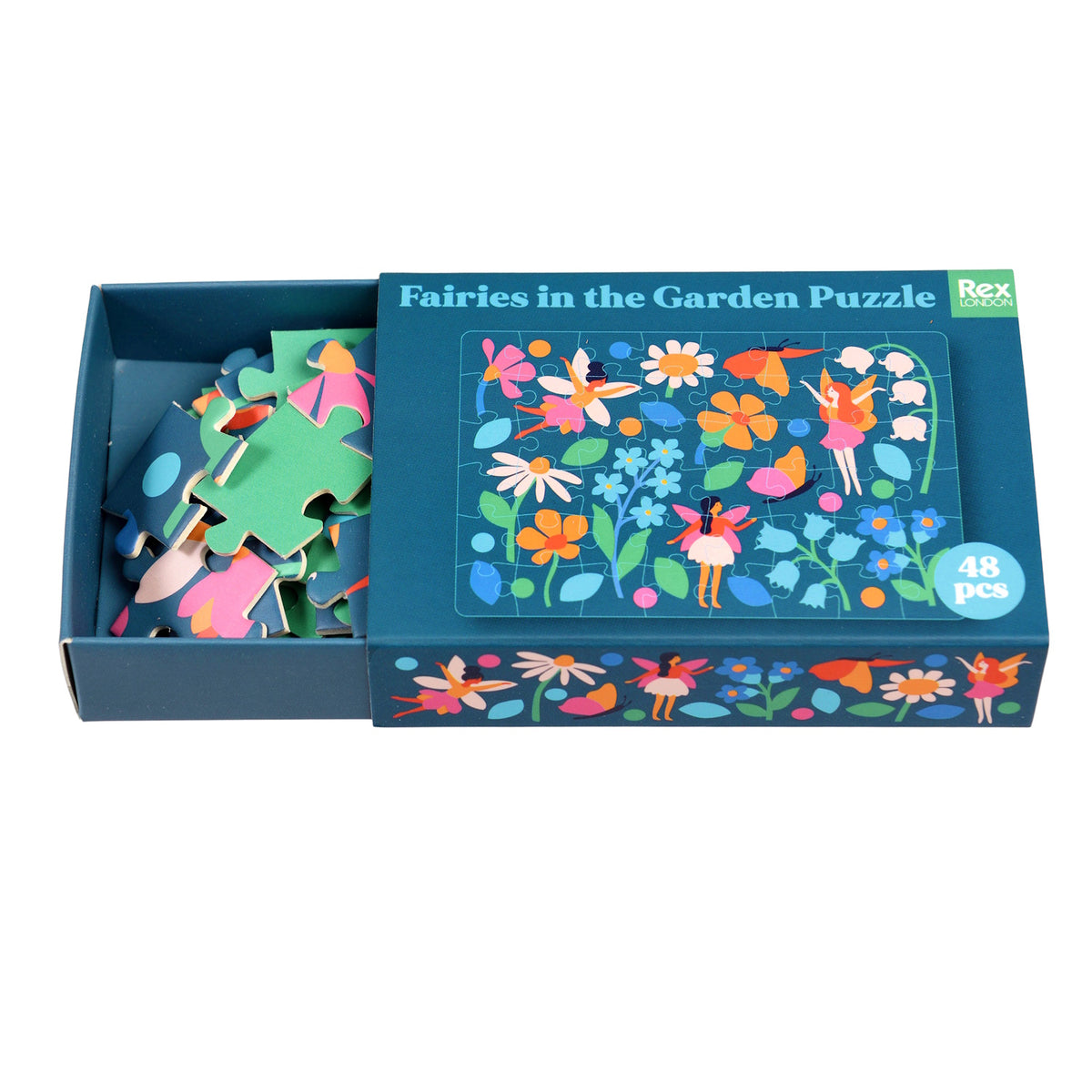 Colorful fairy-themed puzzle with 48 pieces, featuring vibrant flowers and whimsical fairies on a dark blue background, neatly packed in a matchbox-sized box.
