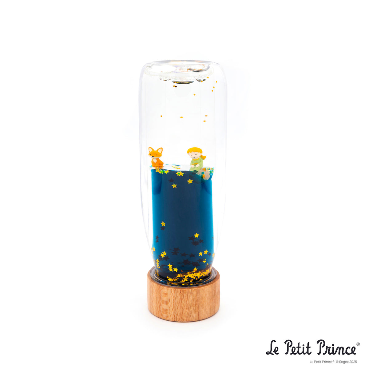 A whimsical glass capsule with a wooden base, featuring figures of a small prince and a fox, surrounded by floating stars in blue liquid, evoking wonder.