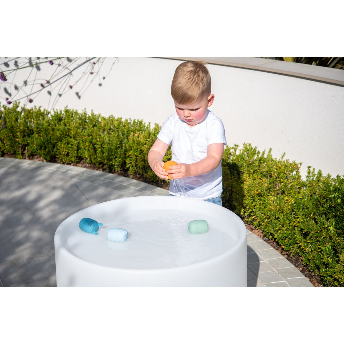 A set of soft silicone animal-shaped squirters in neutral tones, designed for sensory play and water-based fun, perfect for young children.