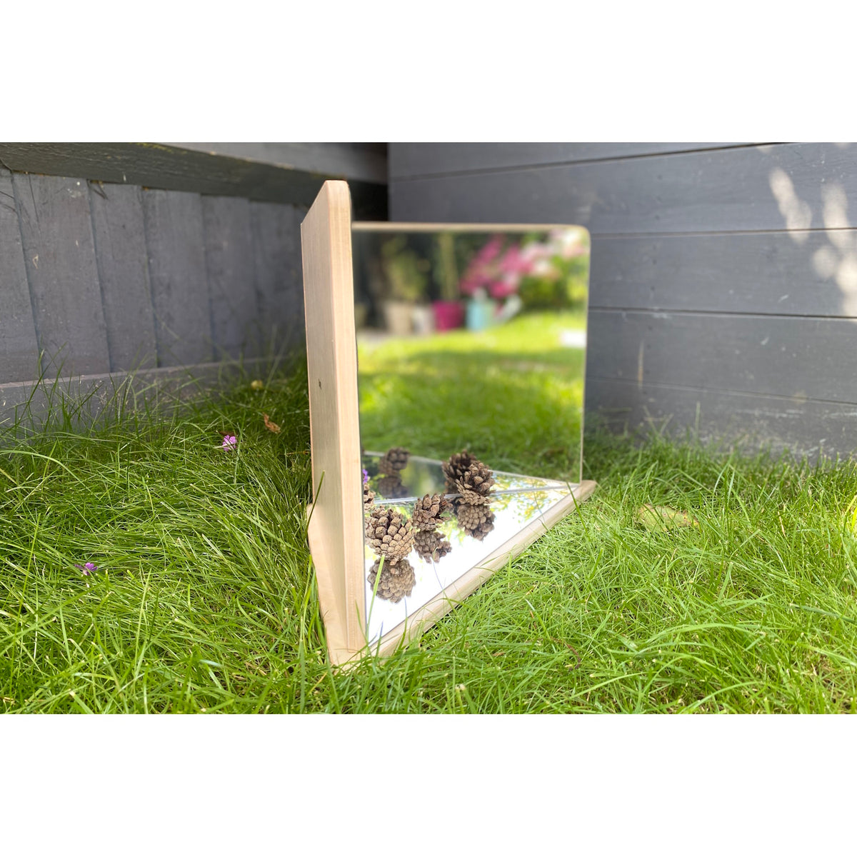 A wooden-framed mirror with four reflective panels arranged to create kaleidoscopic visual effects, ideal for sensory exploration and light play.