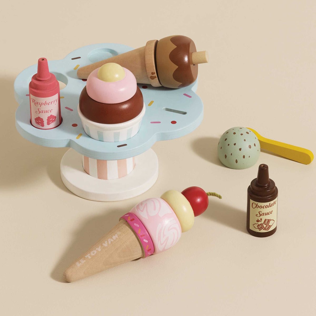 Wooden toy ice cream set with colorful cones, topping bottles, and a pastel blue stand.