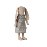 A soft Maileg bunny wearing a charming grey dress adorned with delicate floral patterns.
