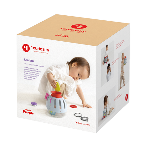 A three-quarter view shows a beige cardboard box for the light blue plastic curiosity lantern toy.