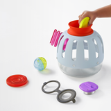 Front view of a light blue plastic toy curiosity lantern with colorful sorting pieces.