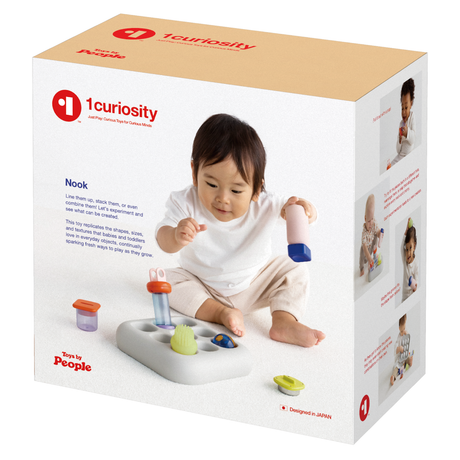 Three-quarter view of the beige and white cardboard packaging box for the 1curiosity Nook toy.