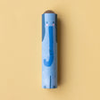 A close-up of a blue elephant-themed kaleidoscope with a friendly illustrated design on a yellow background.
