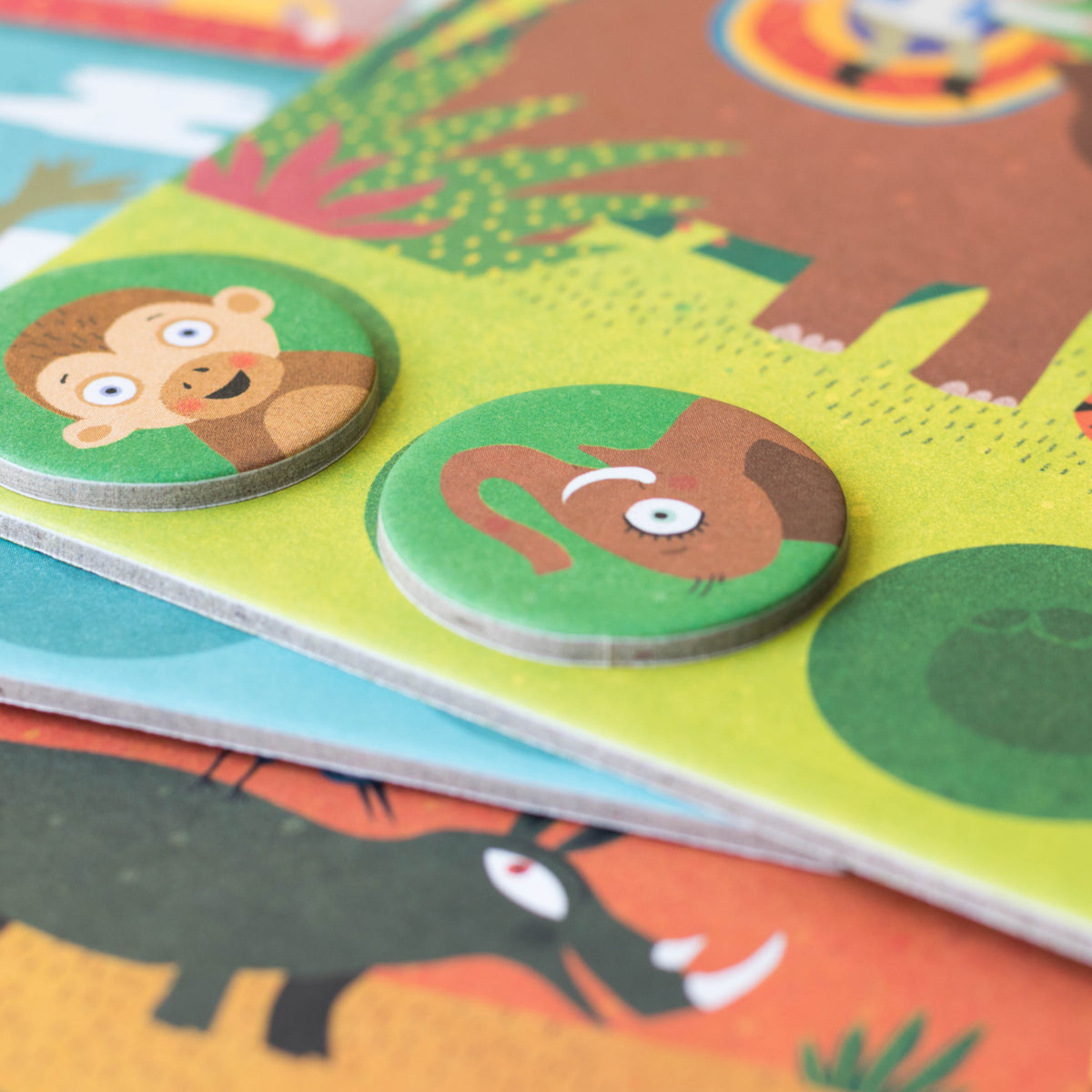 Jungle habitat board with animal tokens – Close-up of the Lotto Habitats game showing a habitat board with a monkey and elephant token.