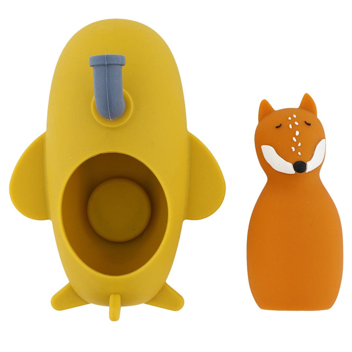 A yellow submarine-shaped item with a small spout is shown next to an orange fox figurine with a smiling expression. The scene is playful and whimsical.