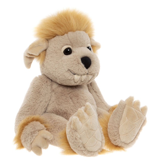 A plush creature toy sitting down, featuring beige fur, fluffy yellow hair, floppy ears, and prominent teeth.