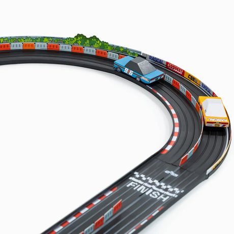 Candylab Roadworks 90-degree turn track expansion with two wooden toy cars racing on a black curved rubber track.