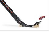 Candylab Roadworks Super Speed playset featuring a red toy car jumping off a black wooden ramp against a white background.