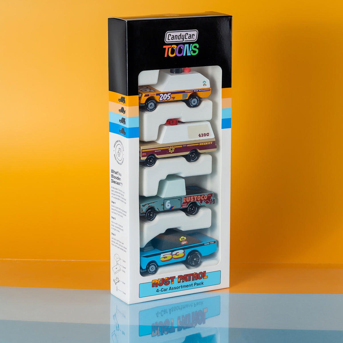 Candylab TOONS Rust Patrol 4-pack of stylized wooden toy cars in retro-themed packaging against a yellow background.