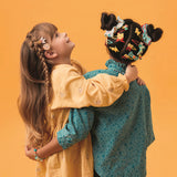 Two girls wearing Nina cat collection hair clips and Emma scrunchies styled in braids and double buns.