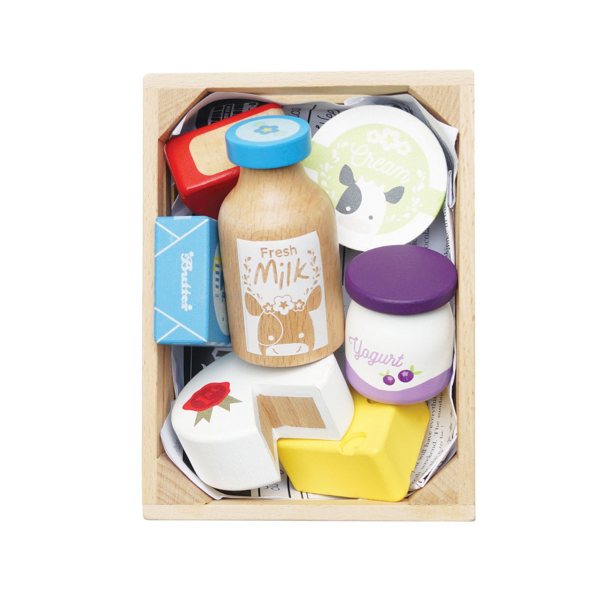 Top-down view of a wooden crate packed with play food dairy items and cheeses on a white background.