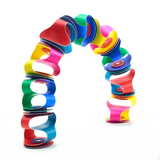 Colorful flexible magnetic toy pieces connected to form a vibrant, freestanding arch against a white backdrop.