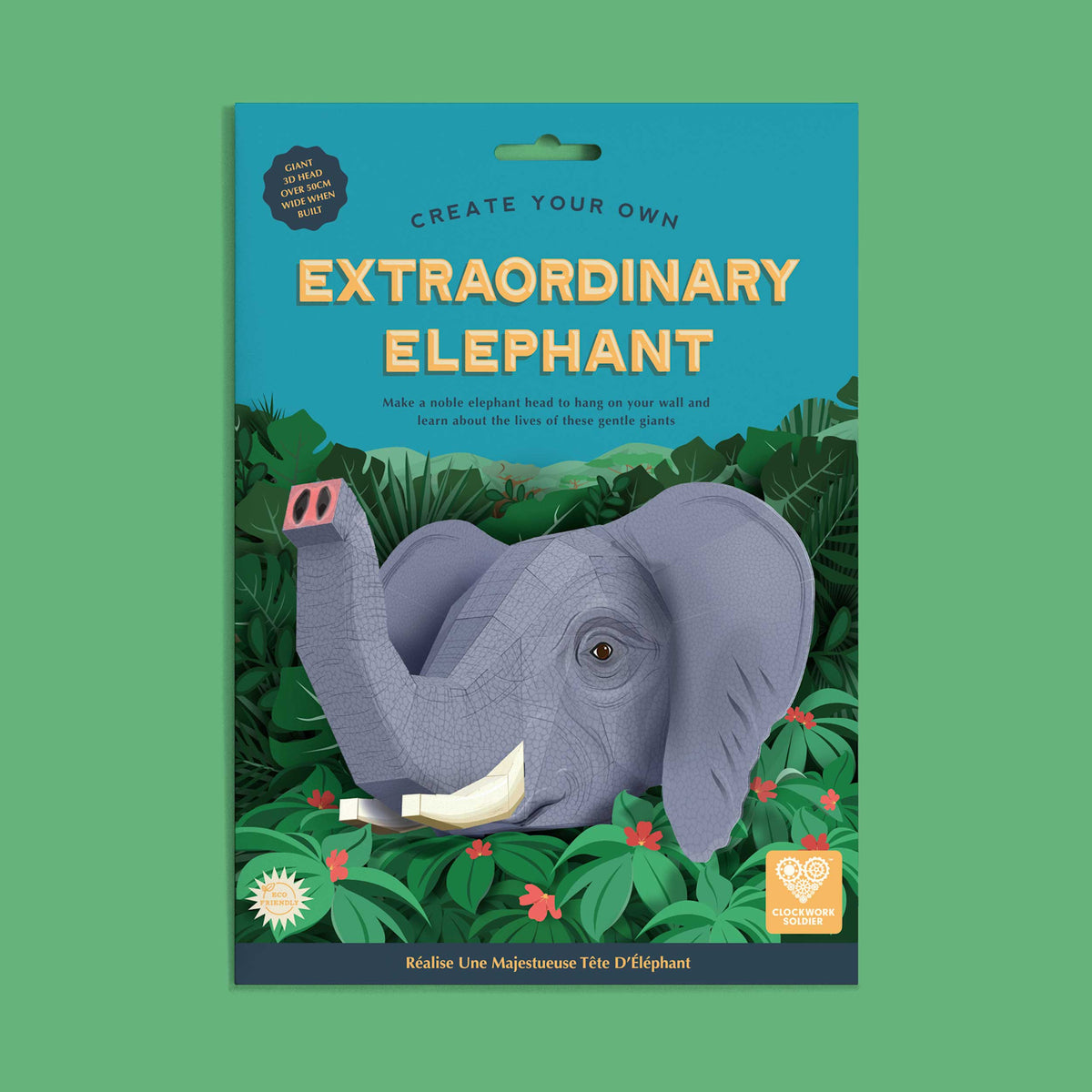 A 3D craft kit cover with a paper elephant head against lush green foliage. Bold text reads "Extraordinary Elephant" on a teal background, evoking creativity.
