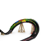 Close-up of a toy car on a Candylab Roadworks banked turn track with wooden supports and colorful racing graphics.