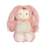 Plush baby doll wearing a fuzzy pink bunny suit with long floppy ears and a small rainbow patch.