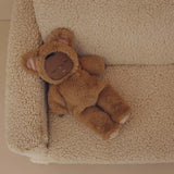 Cozy Dinkums Teddy Mini Caramel doll sleeping on a sherpa armchair.