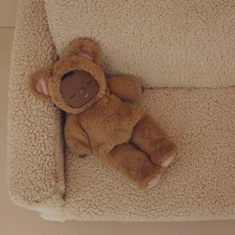 Cozy Dinkums Teddy Mini Caramel doll sleeping on a sherpa armchair.