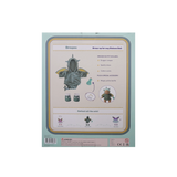 Back of Dragon Outfit Set box showing included item details, doll preview, and safety labels.