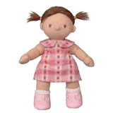 Dinkum doll with brown pigtails wearing a pink plaid rosette dress and pink shoes.