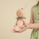 Child holding a Dinky Dinkums Fruity Cuties Peggy Peach plush doll.