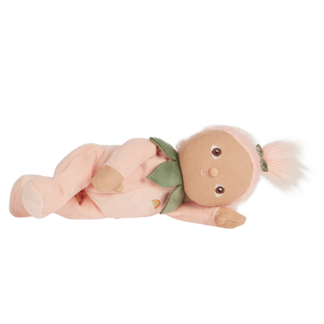 Olli Ella Dinky Dinkums Peggy Peach plush baby doll lying down.