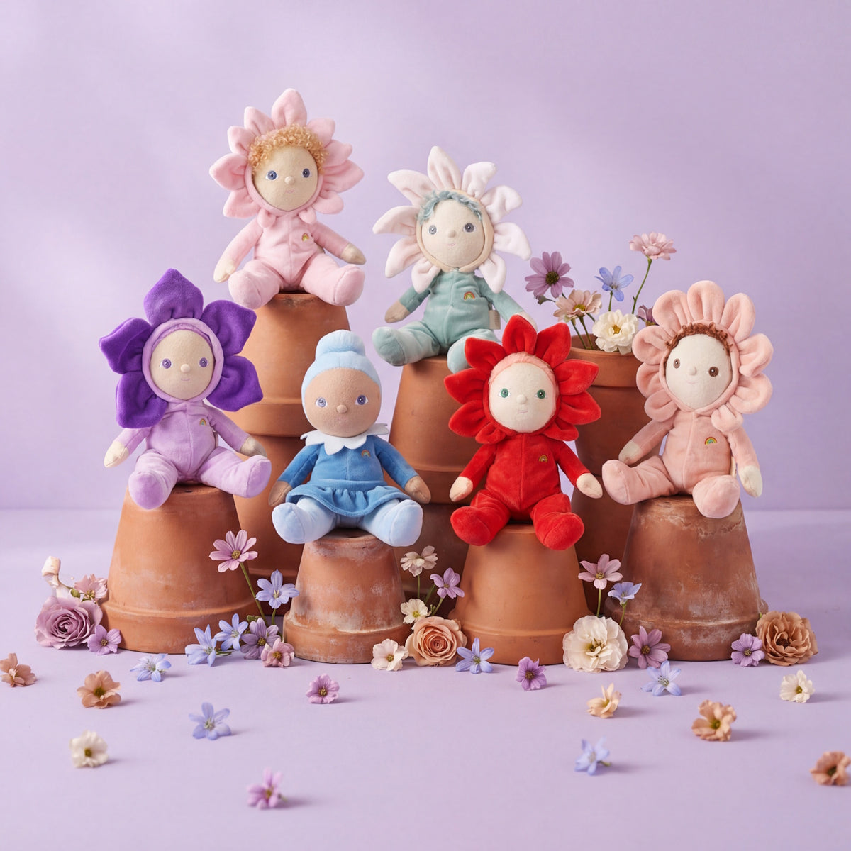 Six Olli Ella Dinky Dinkum flower dolls sitting on upside-down terracotta pots.