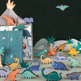Dinosaur advent calendar set featuring wooden figures, paper palm trees, and an erupting volcano.