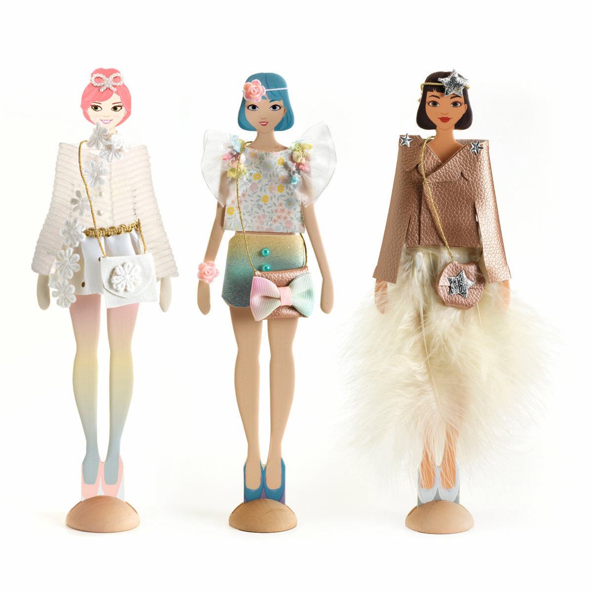 Three fashion dolls display stylish outfits: a white floral dress, a colorful top with a bow, and a chic metallic ensemble with a fur detail.