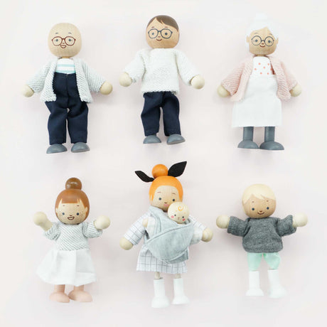 Seven wooden dollhouse family figures arranged in two neat rows against a light pink background.