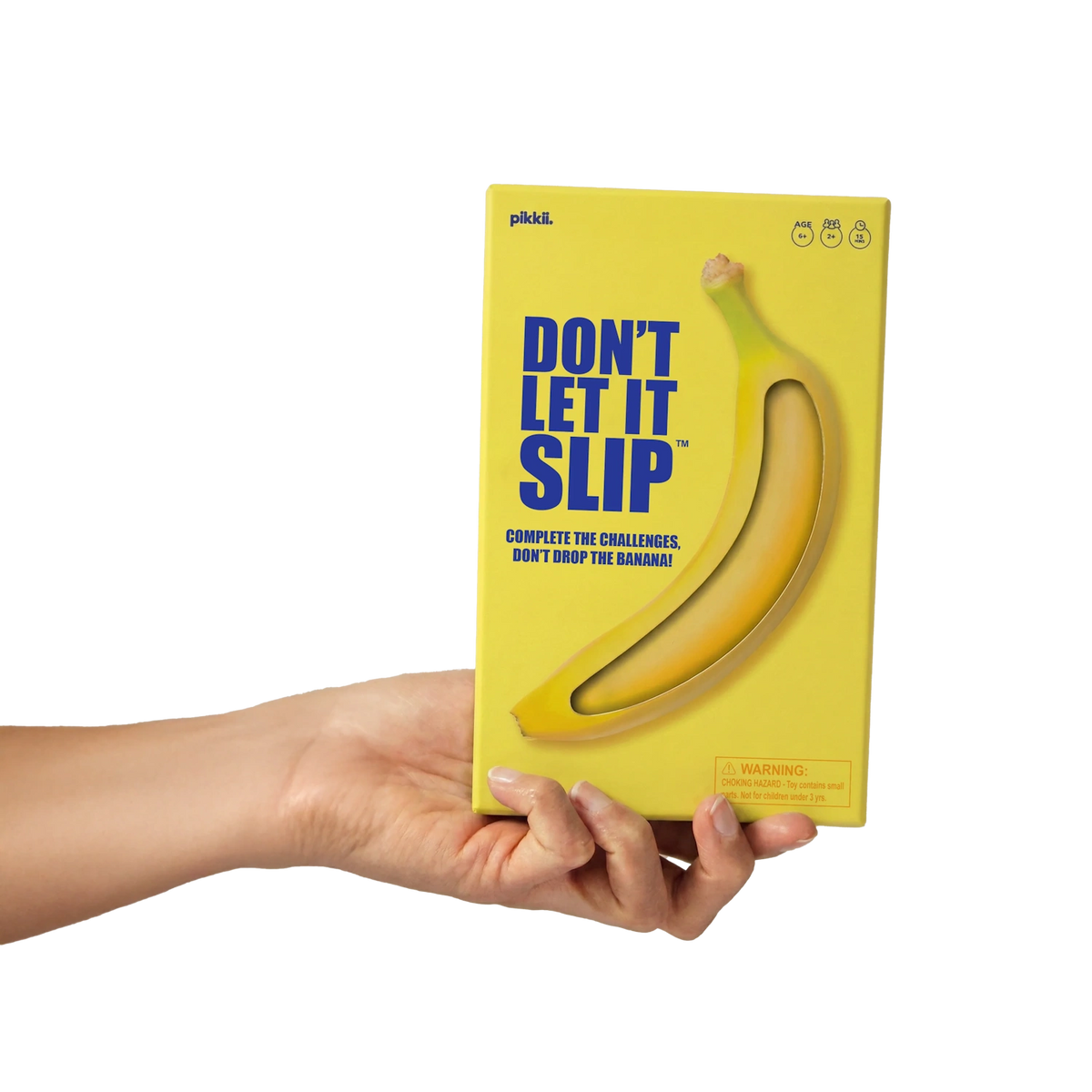 Hand holding the yellow "Don't Let It Slip" game box against a white background.