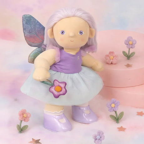 Plush doll wearing a purple and blue fairy outfit set with rainbow wings and a wand.