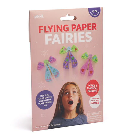 Pink packaging box for "Flying Paper Fairies" showing three colorful paper fairies and a young girl.