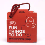 Red "100 Fun Things To Do While travelling" card deck attached to a red hanging loop.