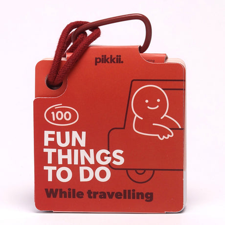 Red "100 Fun Things To Do While travelling" card deck attached to a red hanging loop.