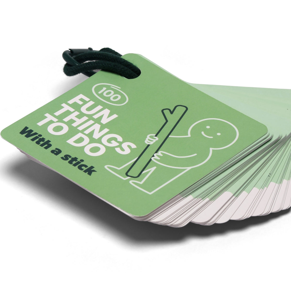 Green card deck titled "100 Fun Things To Do With a stick" held together by a dark green cord.