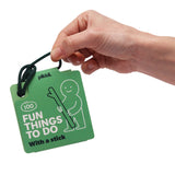 Hand holding green card deck titled "100 Fun Things To Do With a stick" attached to a cord.