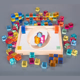 A square wooden tray with a mirrored base and colorful gem-like insets, designed to inspire sensory exploration, pattern making, and visual play.