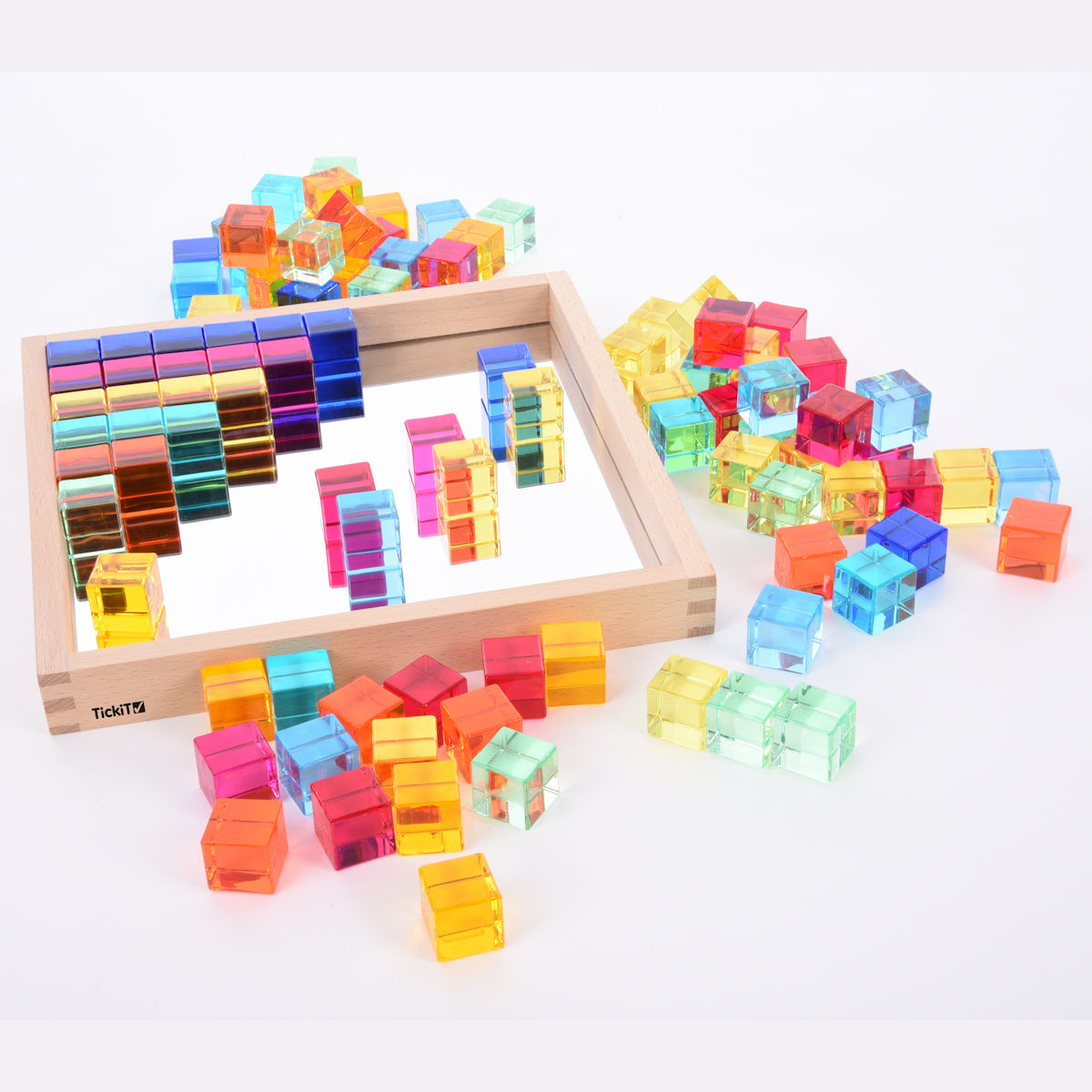 A square wooden tray with a mirrored base and colorful gem-like insets, designed to inspire sensory exploration, pattern making, and visual play.